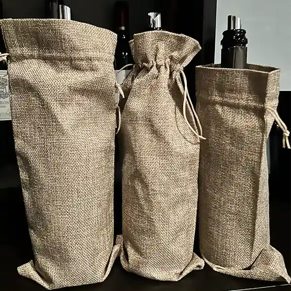 Wine bottles wrapped in burlap bags for blind tasting
