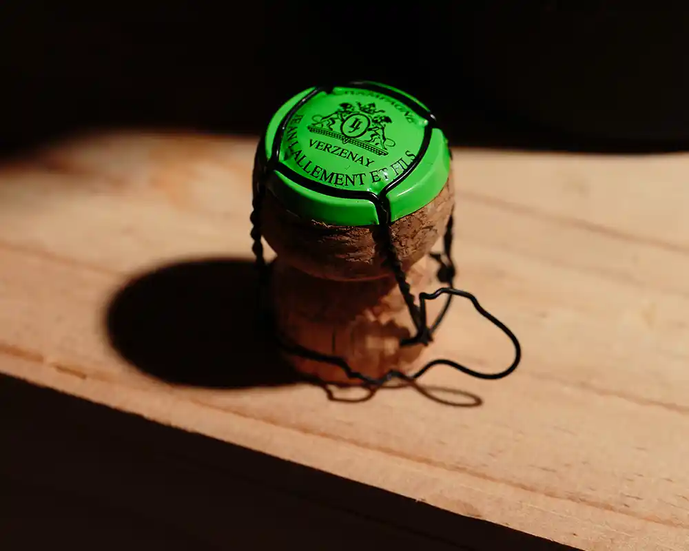 Champagne cork with Verzenay Villement et Fils capsule on wooden surface